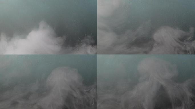 白色墨水像蓬松的云在水背景中旋转和混合