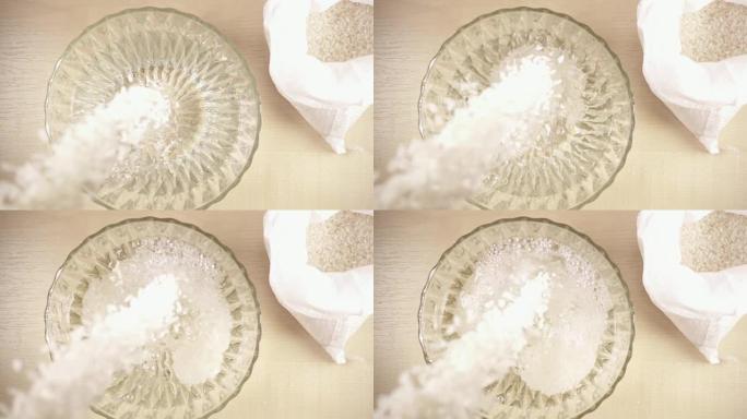 慢动作在碗里撒上白色长粒米饭