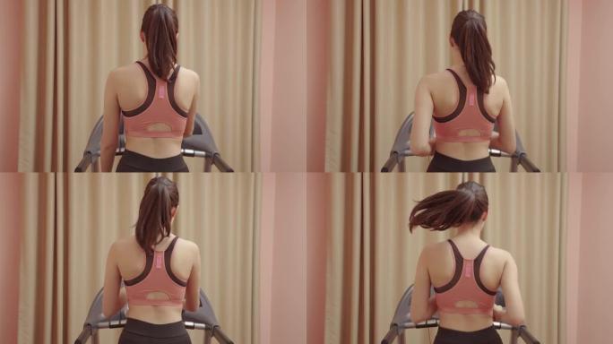 女人在家在跑步机上锻炼，避免PM 2.5灰尘。