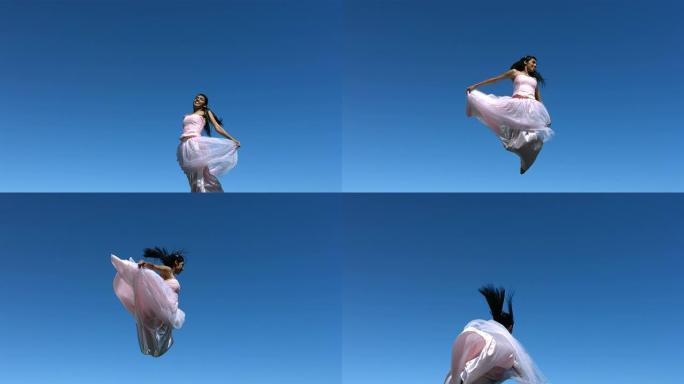穿着连衣裙的女人在空中跳跃，慢动作