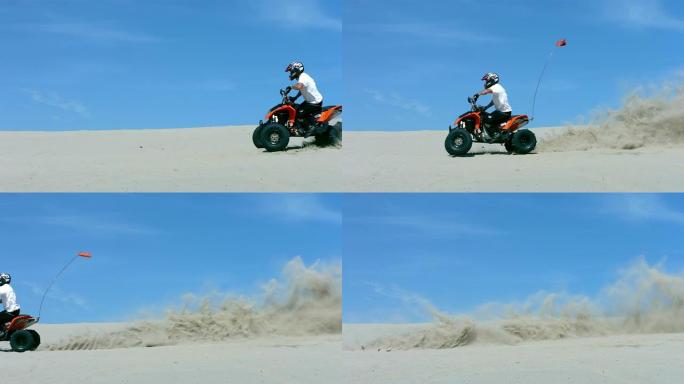 男子骑着四轮摩托穿越沙滩，慢动作