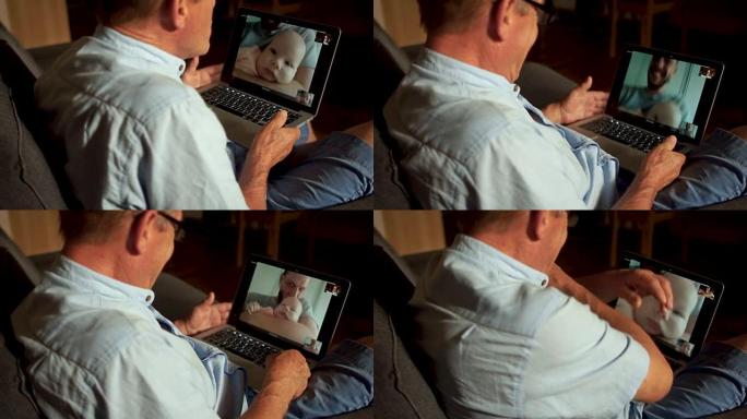 一个成熟的男人在Skype上与他的成年儿子和刚出生的孙子交谈。视频通信，一家三代