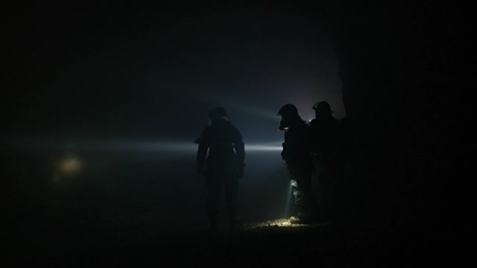 救援部队使用手电筒在黑暗的隧道内搜寻幸存者