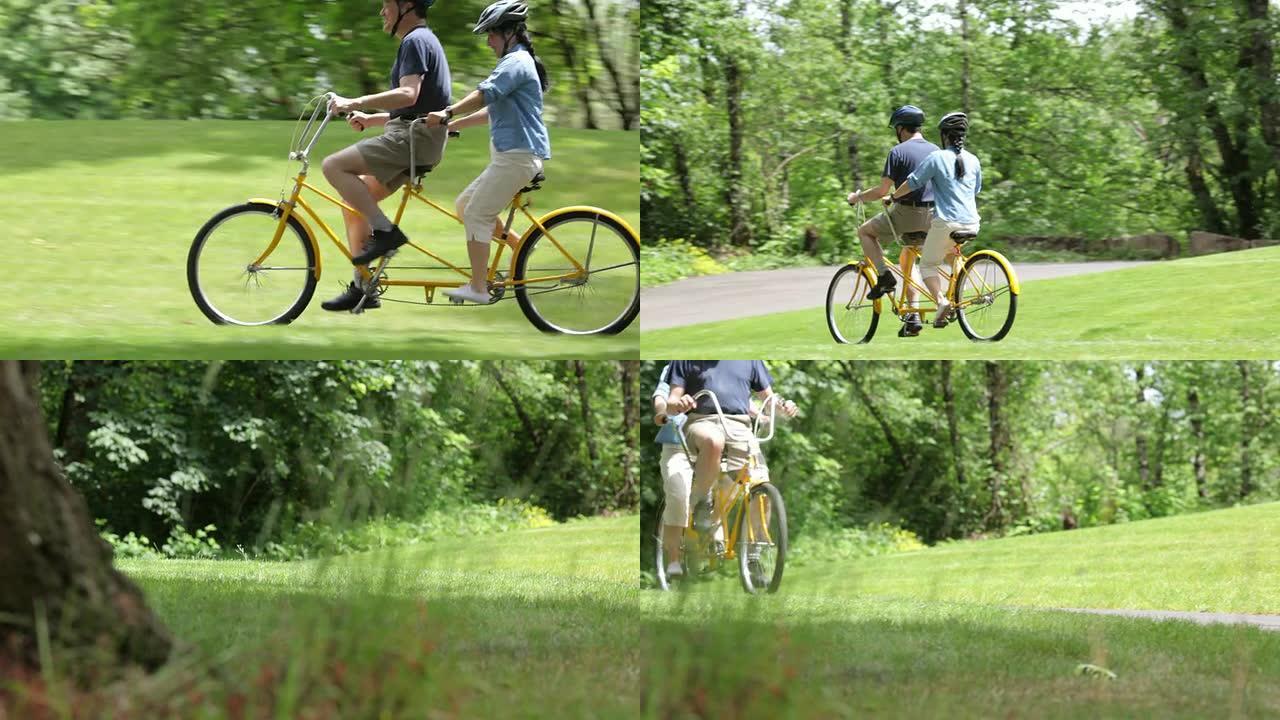 成熟的亚洲夫妇骑双人自行车