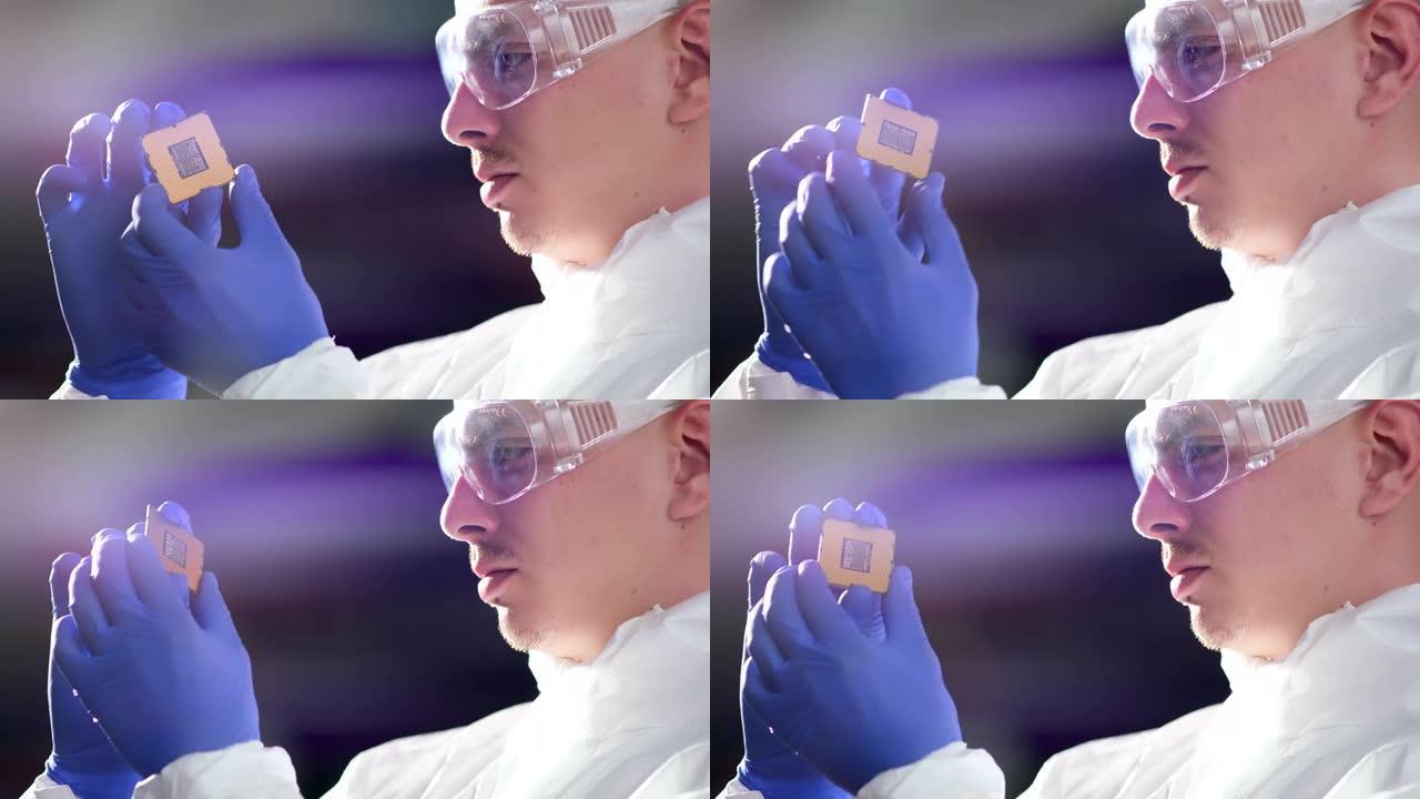 未来技术概念: 一名穿着无菌工作服的工程师戴着手套拿着一个电脑微芯片，并对其进行检查。CPU处理器的