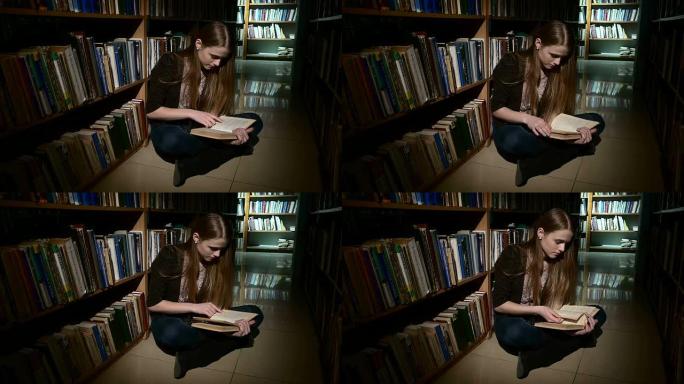 学生坐在地板上看书，真的很热衷。特写