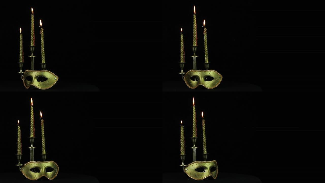 面具和蜡烛在黑色背景上旋转