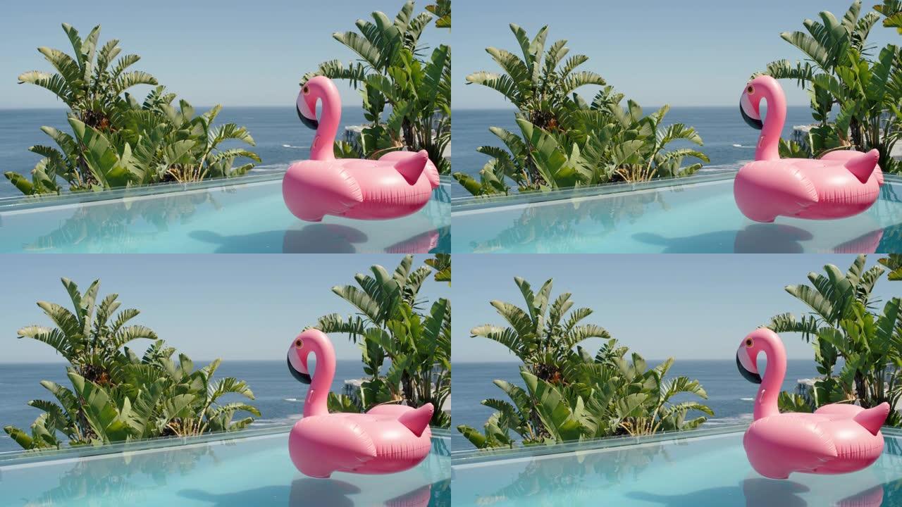 豪华酒店度假村游泳池里的粉色火烈鸟充气游泳管，阳光明媚的暑假可以看到美丽的海景4k镜头