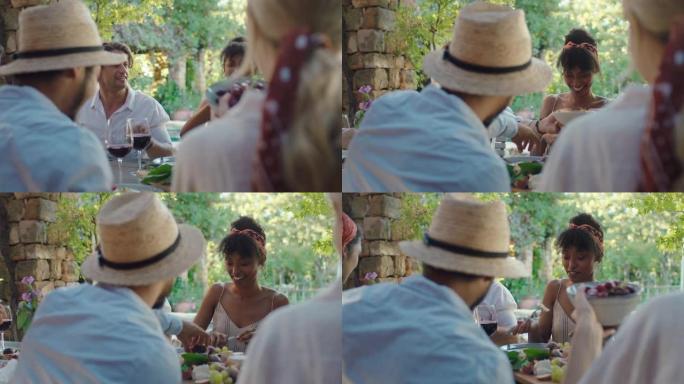夏季晚宴，朋友坐在户外餐桌上吃地中海食物，享受盛宴4k镜头