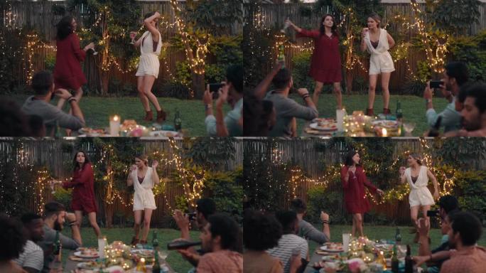 朋友在晚宴上跳舞庆祝美丽的女人一起跳舞，享受周末在家里4k后院聚会的乐趣