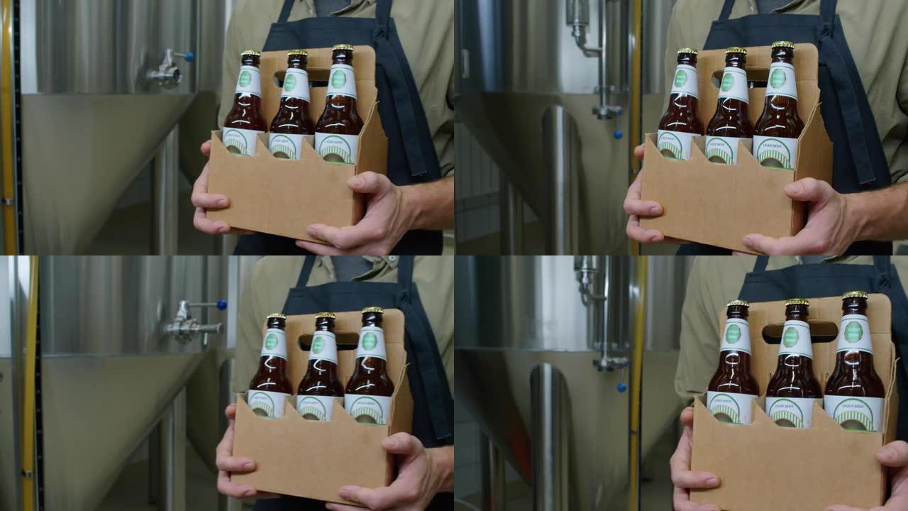 匿名啤酒厂工人携带瓶装啤酒