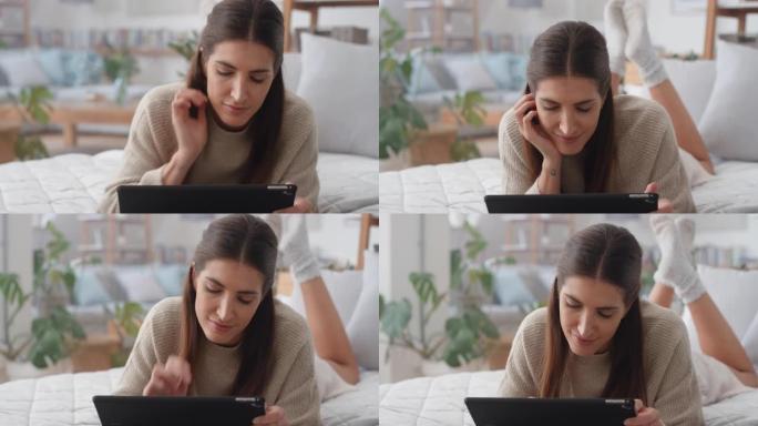 美丽的女人使用平板电脑在床上放松浏览互联网输入社交媒体消息在线移动触摸屏技术4k镜头