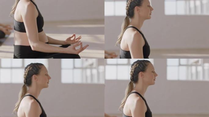 瑜伽课年轻怀孕的白人妇女练习莲花姿势冥想享受日出时在健康健身工作室的正念呼吸锻炼
