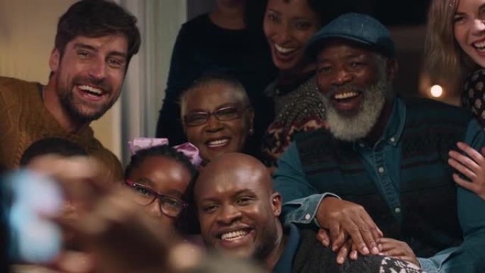 非裔美国人家庭在圣诞晚宴上与朋友合影，使用智能手机拍摄节日团圆聚会，在家庆祝节日4k
