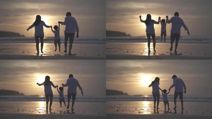 亚洲印尼幸福家庭父亲母亲和孩子在日落时在海滩上共度时光的肖像-关系，纽带，养育，笑和爱