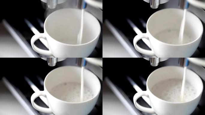 咖啡机将热牛奶倒入杯子中