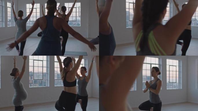 瑜伽课教练教孕妇锻炼健康的生活方式练习树木姿势享受日出工作室的集体体能锻炼