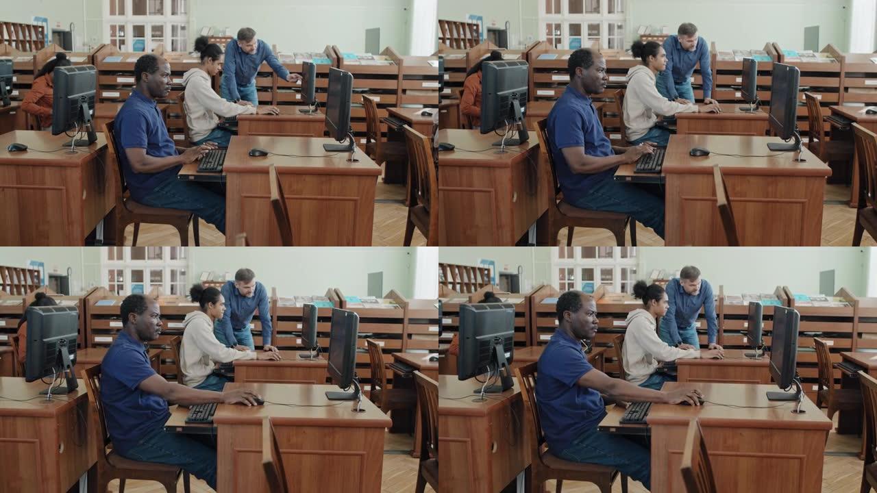 在图书馆的计算机上进行测试的学生