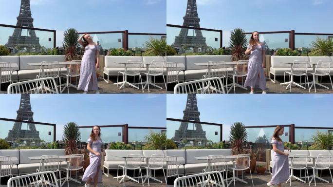 一个穿着蓝色长裙的美丽少女站在一家餐厅的埃菲尔铁塔的背景下，她拉直头发，离开了裙子，被文字空间的风吹