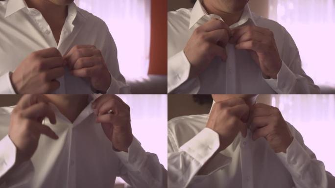 特写，肖像: 开朗的新郎扣上衬衫，准备婚礼