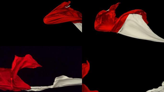 黑色背景上流动的白色和红色织物，慢动作