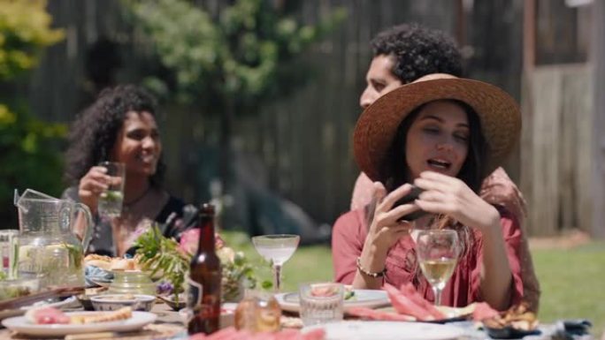 快乐夏日年轻人庆祝花园派对午餐玩得开心聊天用智能手机分享健康食物享受周末团聚在美丽的夏日户外放松