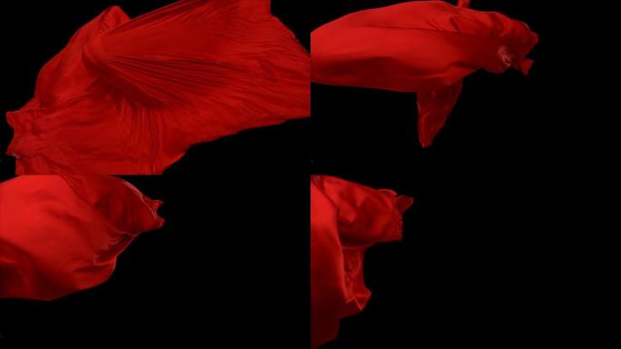 黑色背景上流动的红色织物，慢动作