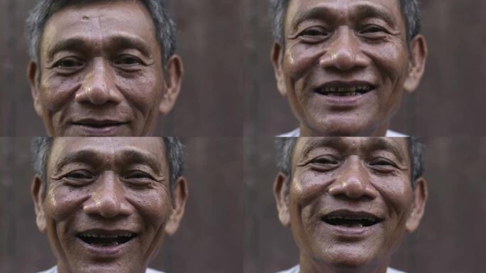 成熟的亚洲男人微笑着看着相机的特写镜头
