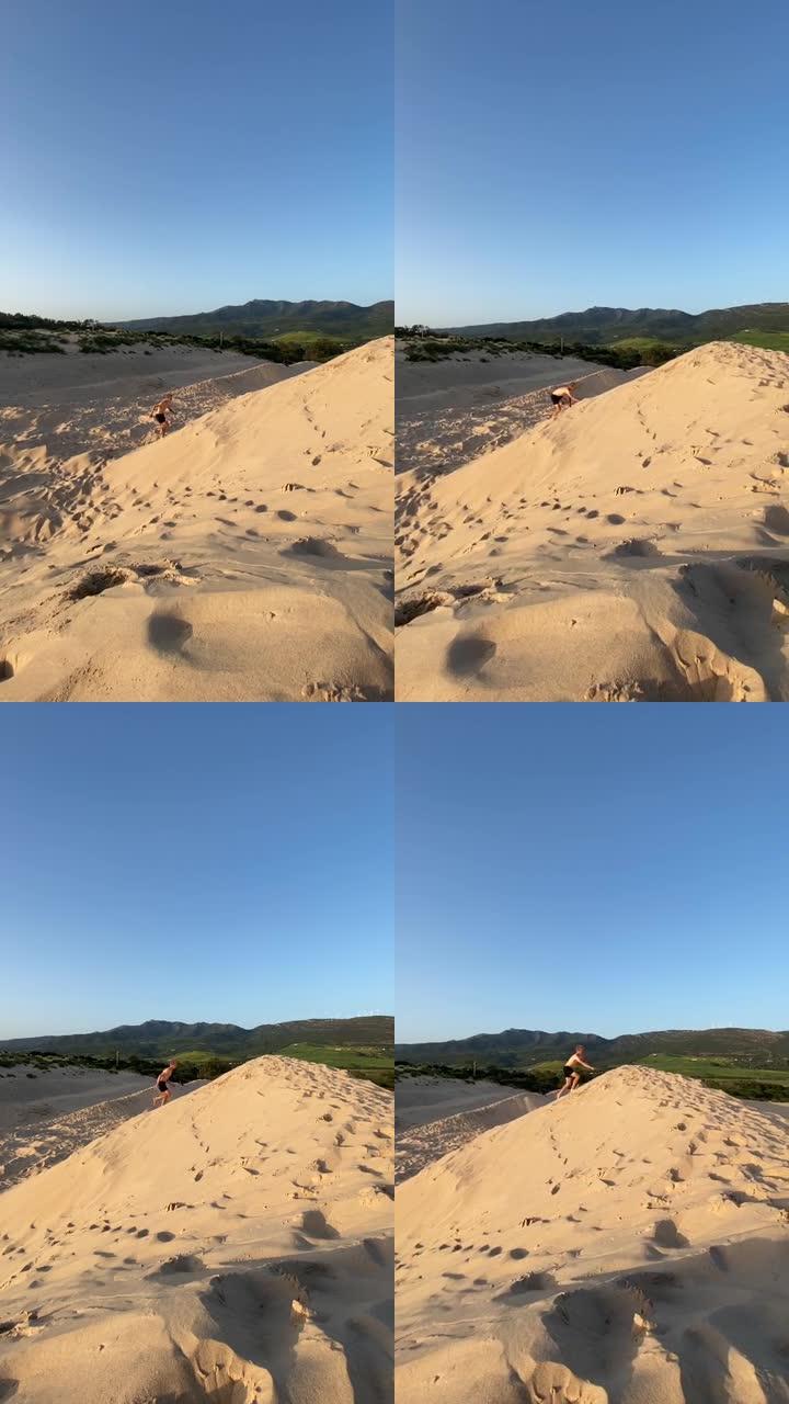 男子在沙丘上玩耍竖屏竖拍沙土黄沙山水风光