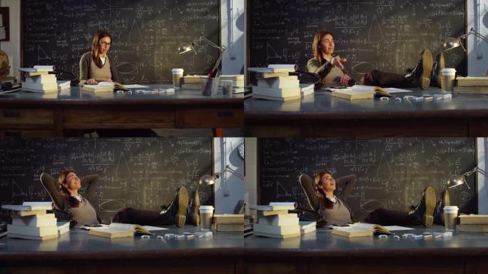 大学教室里年轻女教师的肖像，用数学公式在黑板前的桌子上工作。理科生在大学图书馆休息，放松，伸展