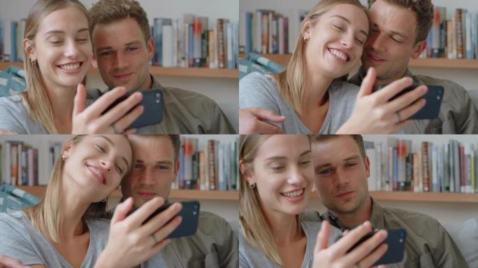 幸福的情侣一起用智能手机在家里沙发上放松美丽的女人在社交媒体上分享关系4k