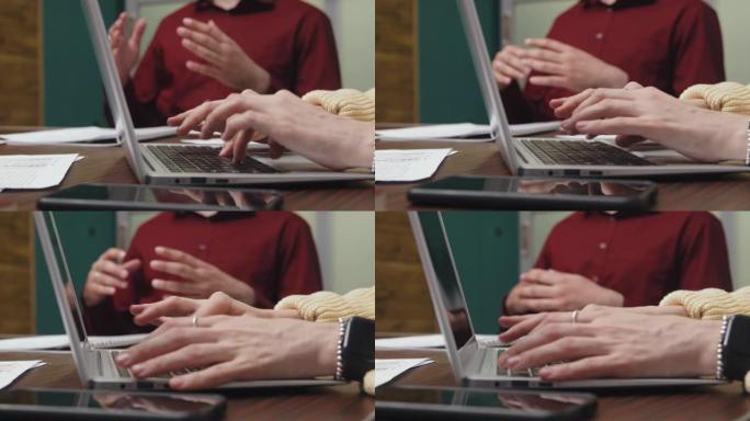会议上在笔记本电脑上打字总结的女人的手
