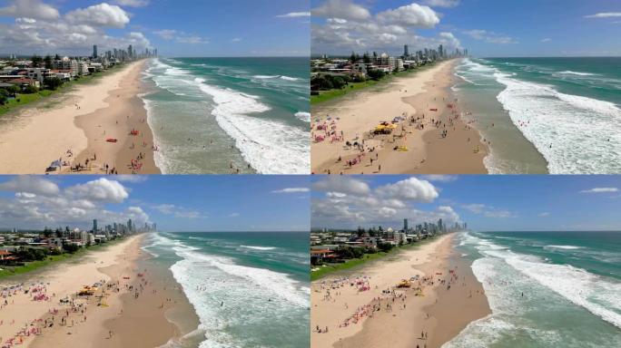 4k鸟瞰图黄金海岸北伯利了望台的迈阿密海滩上方，游客和在沙滩上冲浪的实时镜头