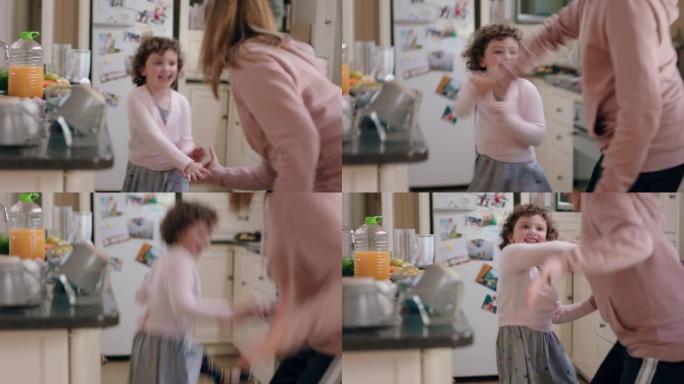 快乐的十几岁的女孩和妹妹在厨房跳舞，兄弟姐妹周末一起在家享受有趣的舞蹈