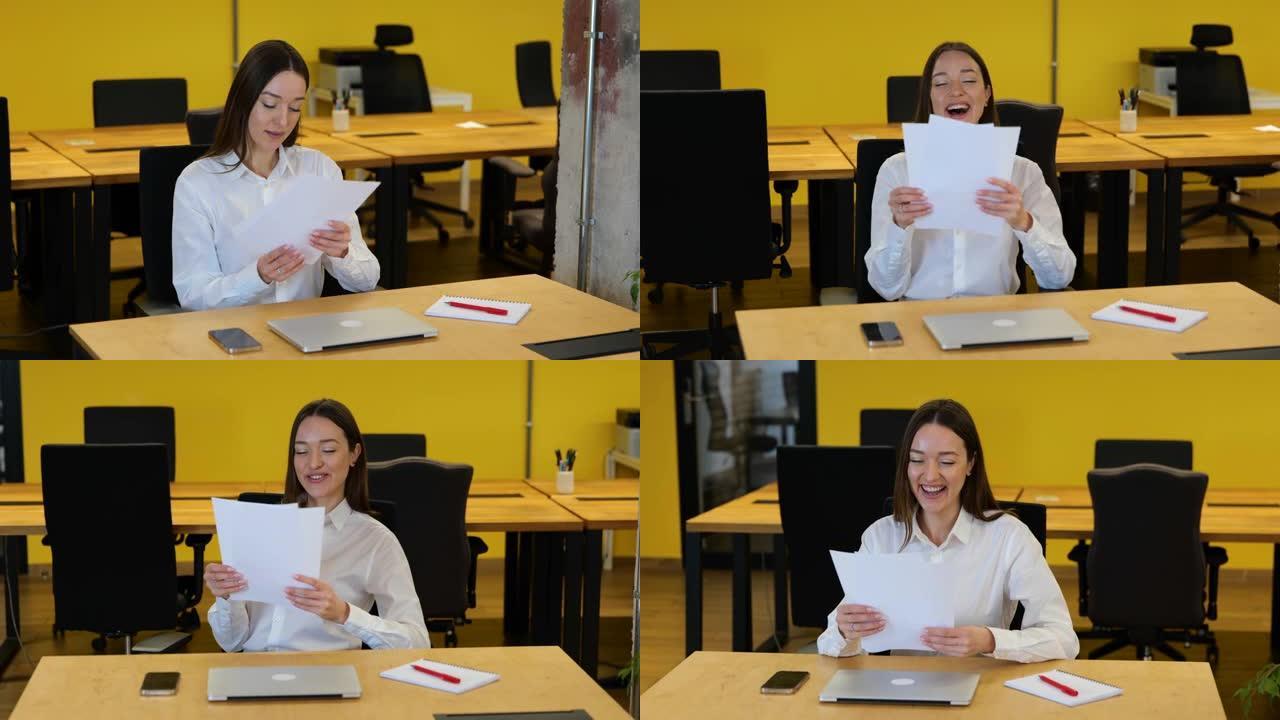 慢动作视频。穿着白衬衫和灰色裤子的白人女商人坐在她的工作桌面上，从大学里拿论文，阅读和微笑。
