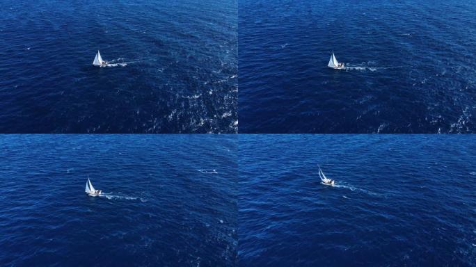 旅行自由。在海中航行的白色美丽游艇的无人机视图
