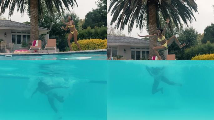 快乐的非洲裔美国妇女跳进游泳池，在水下泼水，玩得开心，暑假享受夏天穿着黄色比基尼4k镜头