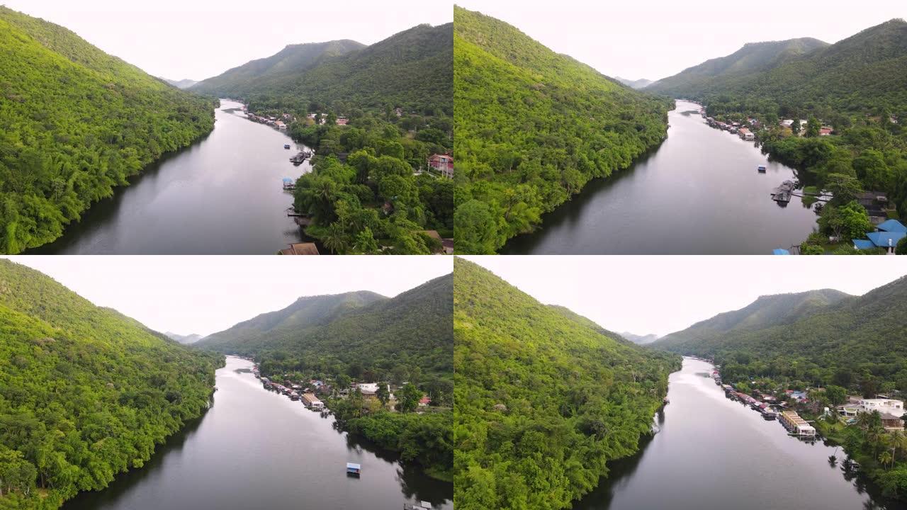 沿河漂流屋绿色自然的鸟瞰图，飞越热带绿色森林和宁静的河流