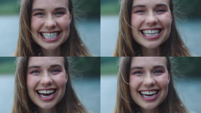 画像快乐的年轻女子笑着感觉快乐的户外湖4k
