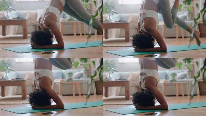 健康混血女子在家练习瑜伽，在客厅练习支撑倒立姿势，享受早晨健身锻炼4k镜头