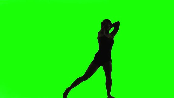 年轻女子跳现代舞的剪影。绿屏