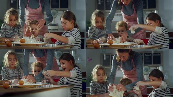 可爱的孩子在厨房里帮助母亲烘烤的肖像。年轻的兄弟姐妹在周末玩得开心，合作，做面团和饼干。童年、幸福和