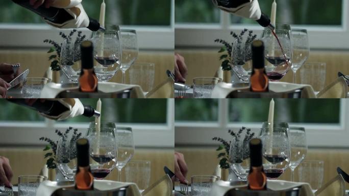 高清库存: 晚餐时将红酒倒入精美的玻璃杯中