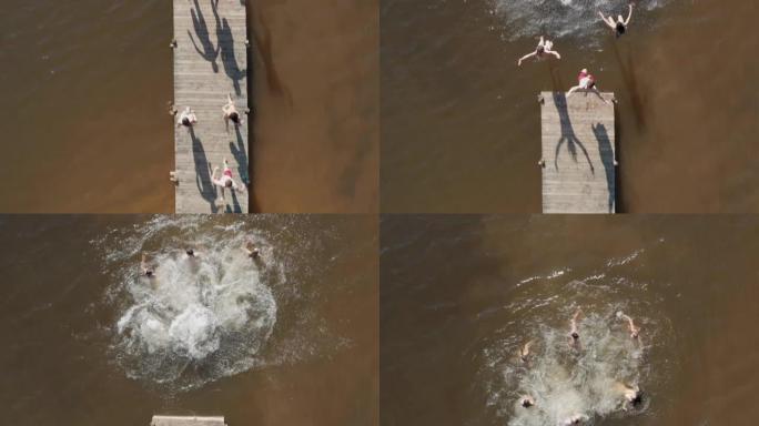 鸟瞰图的朋友从湖上跳下码头，玩得开心，在暑假享受自由，从上面看无人机