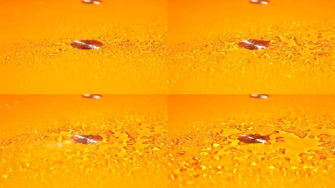 在橙色表面上喷洒水滴