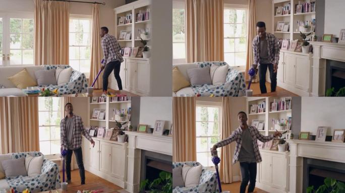 有趣的非裔美国人在家里用吸尘器跳舞庆祝成功，跳舞打扫客厅，周末做家务4k