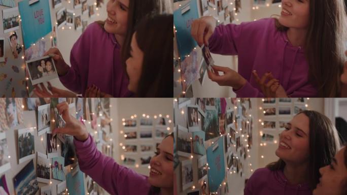 快乐的十几岁的女孩在卧室的墙上贴照片，制作拼贴画，享受周末和朋友一起出去分享照片集