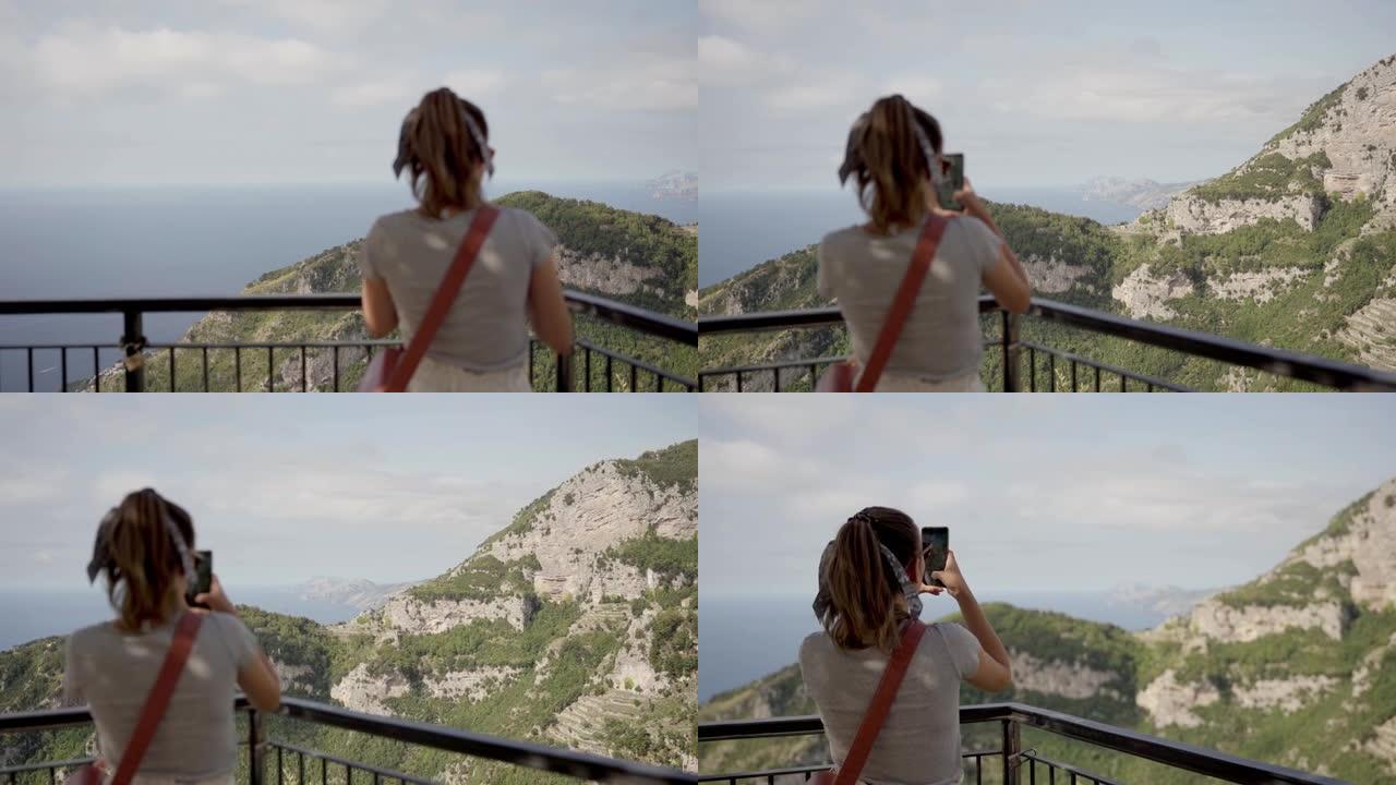 在意大利阿马尔菲海岸悬崖海边观看众神之路的高加索女游客