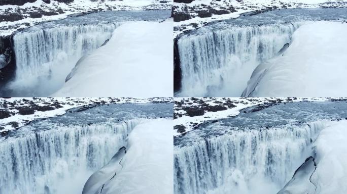 瀑布冬季边缘飞越风景史诗空中飞行冰岛著名瀑布周围的雪冰水流过高崖灵感史诗尺度自然冒险