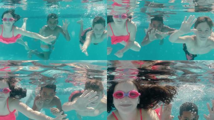 快乐的孩子在游泳池水下游泳微笑挥舞的手孩子们享受游泳一起漂浮在水晶般清澈的水中暑假